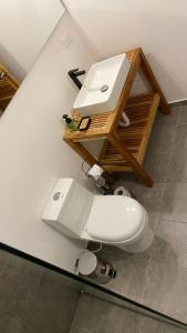 a bathroom with a white toilet and a sink at Bahía Santamaría in Moñitos