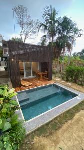 a small swimming pool in front of a house at Bahía Santamaría in Moñitos