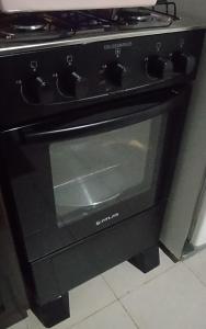 a black oven sitting in a kitchen at Miguel Departamentos 2 in Puerto Iguazú