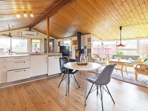 a kitchen and dining room with a table and chairs at Holiday home Frederikshavn II in Frederikshavn