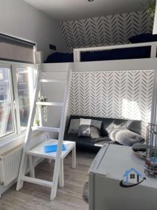a small room with a bunk bed and a couch at Acaster House, Rooms 1 to 5, free parking, SUPER fast wi-fi, en-suite, corporates welcome in Kettering