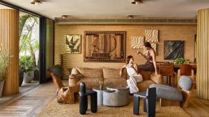 two women sitting on a couch in a living room at Santa Monica Proper Hotel, a Member of Design Hotels in Los Angeles