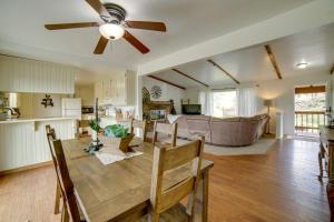 eine Küche und ein Wohnzimmer mit einem Tisch und einem Deckenventilator in der Unterkunft 30-Acre Witter Springs Ranch with Barn and Views! in Upper Lake