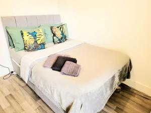 a white bed with pillows and towels on it at One bedroom apartment with a terrace in Angel (Islington)! in London