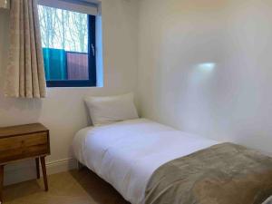 a small bedroom with a bed and a window at Modern Space 20 minutes from Dublin Airport in Dunboyne