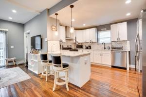 a large kitchen with white cabinets and wooden floors at Columbus Vacation Rental about 4 Mi to Downtown! in Columbus