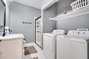 a white laundry room with a washer and dryer at Columbus Vacation Rental about 4 Mi to Downtown! in Columbus