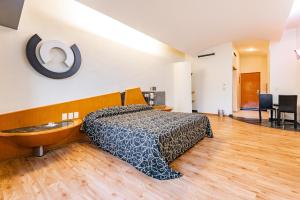 een slaapkamer met een bed en een houten vloer bij Hotel Pasadena CDMX in Mexico-Stad