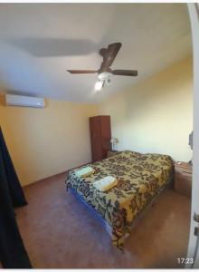 a bedroom with a bed and a ceiling fan at ALVY in Victoria