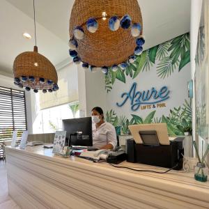 a person wearing a mask behind a counter in a store at Azure Lofts & Pool in San Andrés