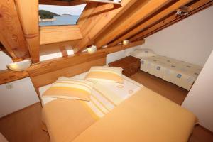 a small room with a bed and a window at Rooms by the sea Vis - 3034 in Vis