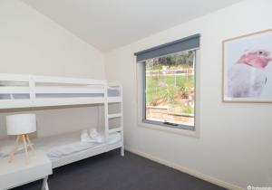 Ένα ή περισσότερα κρεβάτια σε δωμάτιο στο Kookaburra Cottage A Perfect Family Getaway