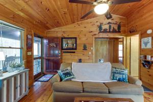 a living room with a couch and a ceiling fan at Blue Ridge Cozy Cabin in the Woods with Hot Tub! in Blue Ridge