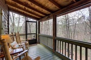 a screened in porch with rocking chairs and large windows at Blue Ridge Cozy Cabin in the Woods with Hot Tub! in Blue Ridge