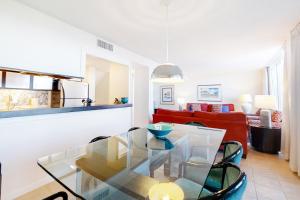 a dining room and living room with a glass table at Captains Court 1004 in Fernandina Beach