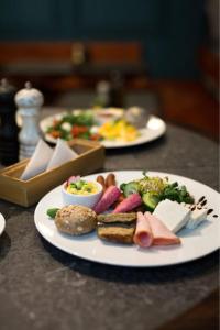 two plates of food on top of a table at Apartament Patisserie by Good Time in Łódź