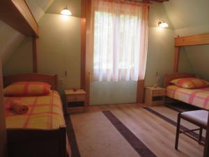Habitación pequeña con 2 camas y ventana en Family friendly house with a parking space Kuzelj, Gorski kotar - 20980, en Kuželj
