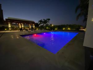 a swimming pool at night with blue illumination at JUAN DOLIO villa Palmera in Los Corrales