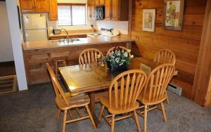 a kitchen with a wooden table and four chairs at Seven Springs Swiss Mountain 3 Bedroom Standard Condo, Sleeps 8! condo in Champion