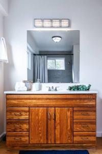 a bathroom with a sink and a mirror at Crown Point Beach Retreat in San Diego
