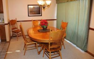 a dining room with a wooden table and chairs at Seven Springs 2 Bedroom Standard Condo, Sleeps 10! condo in Champion
