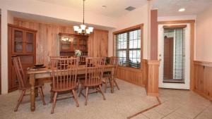 a dining room with a wooden table and chairs at Seven Springs Woodridge 3 Bedroom Premium Condo, Sleeps 7! condo in Champion