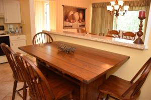 a wooden table in a kitchen with chairs around it at Seven Springs 2 Bedroom Standard Condo with Private Deck! condo in Champion