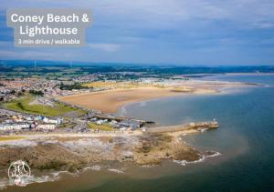 an aerial view of a beach and lighthouse at COASTAL RETREAT Town Centre Entire Property, Very Close to Sea & Restaurants, 2 King Size Beds in Porthcawl