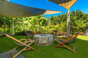 two chairs and a table with an umbrella at Andaz Villa 810 villa in Wailea