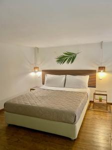 a bedroom with a bed with a green plant on the wall at Nohi's House in the historic center in Lecce