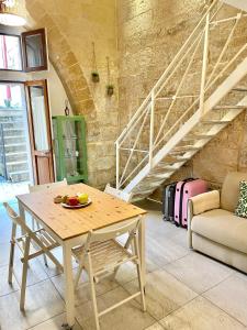 a table with a bowl of fruit on it in a room at Nohi's House in the historic center in Lecce +25 photos