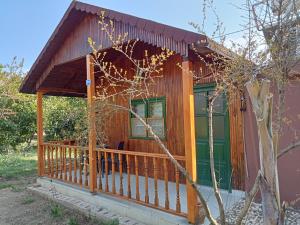 a cabin with a porch and a green door at Bungalow with access to a large garden near beach in Kemer