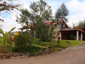 a house on the side of a road at Casa Bartzis, every stay comes with a free professional massage in Orosí