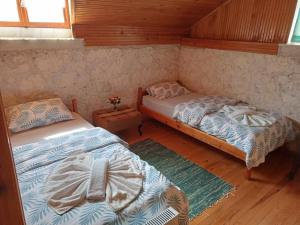 a bedroom with two beds in a cabin at Detached stone house with access to a large garden near beach in Kemer