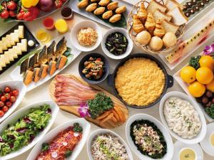 a table filled with different types of food in bowls at Hotel Hankyu RESPIRE OSAKA in Osaka