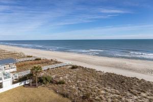 a view of the beach from the balcony of a beach house at 0606 Endless Summer by Atlantic Towers in Carolina Beach +9 photos