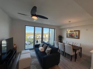 a living room with a couch and a dining room at Condo Cuteness with Stellar View ~ On The Water & Perfectly Located in Sarasota