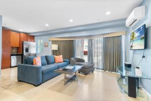 a living room with a blue couch and a table at Isle of Venice Residence and Marina in Fort Lauderdale