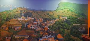 una pintura de un pueblo en una montaña en The Red House Bandipur, en Bandipur