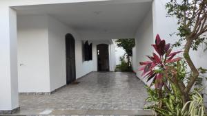 大伊瓜巴的住宿－A Casa para a sua Família em Iguaba Grande, até 9 pessoas，一条带走廊的白色建筑走廊