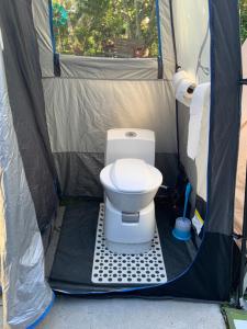a toilet inside of a tent with a toilet brush at Union Street Hideaway in Waihi