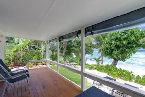 a porch with a view of the beach and the ocean at Ann's Island Beach Studio in Rarotonga +3 photos
