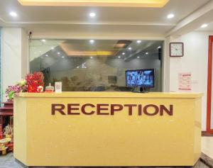 a reception desk in a store with a television at Rosy Motel Trung Yên in Hanoi