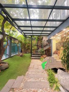 a patio with a black pergola and a staircase at Rosy Motel Trung Yên in Hanoi