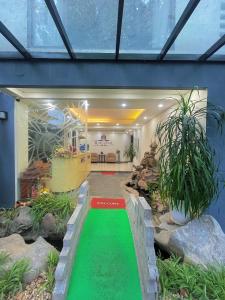 a house with a green lawn in the middle of it at Rosy Motel Trung Yên in Hanoi