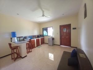 a room with a kitchen with a table and a counter at Teresa house Rental Villa Teresa Philippines in Moalboal