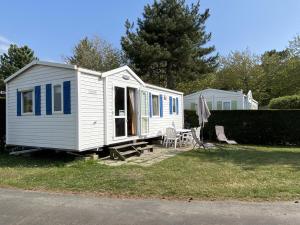 biały mały domek siedzący w trawie w obiekcie Mobil-home à Fouras : Proche Plage, 2 Chambres, TV, Plancha, Parking, Idéal Famille - FR-1-709-58 w mieście Fouras