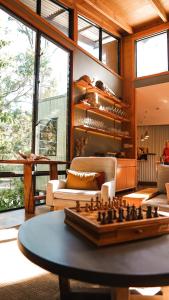 a living room with a chess board on a table at Paperbark Camp in Woollamia
