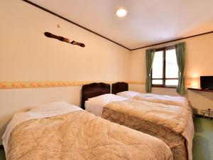 Postel nebo postele na pokoji v ubytování Kurumayama Kogen Guesthouse Urara