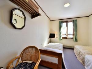 Postel nebo postele na pokoji v ubytování Kurumayama Kogen Guesthouse Urara